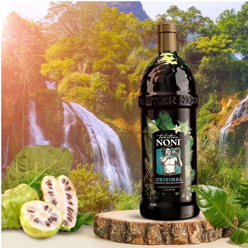 The same litre beside a cut noni fruit, showing the pale flesh and the dark seeds inside it.